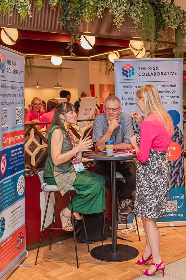 Sabrina Segal, Nigel Kippax and Caron Bradshaw chat on The Risk Collaborative stand at CFG's Annual Conference 
