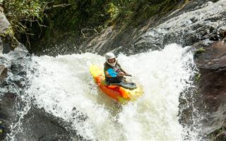 a person in a kayak heading down a steep waterfall. The image represents fear and risk taking