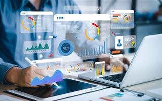 hand with pen at laptop surrounded by data symbols