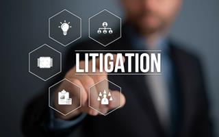 a man points towards a selection of virtual buttons and choses the word litigation